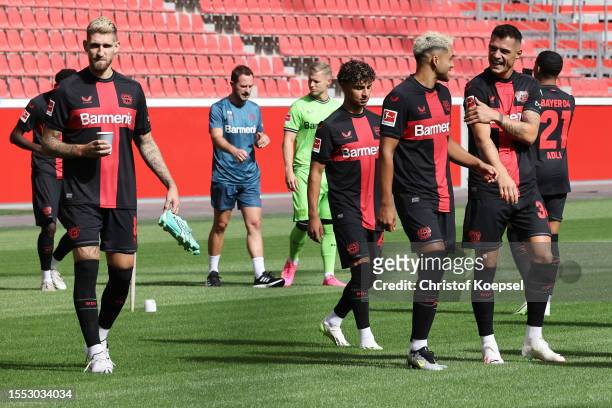 Robert Andrich, Exequiel Palacios and Granit Xhaka of Bayer Leverkusen enter the pitch prior to the team presentation at BayArena on July 18, 2023 in...