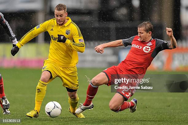 Josh Williams of the Columbus Crew controls the ball as Terry Dunfield of Toronto FC defends on October 28, 2012 at Crew Stadium in Columbus, Ohio.