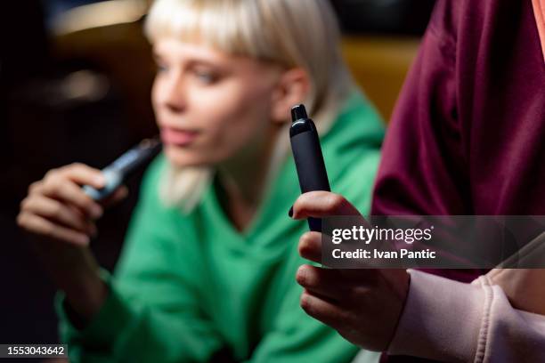 close up of smoking a vape. - electronic cigarette stockfoto's en -beelden