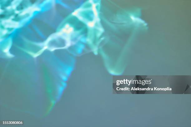 abstract empty wall with dark emerald green, turquoise and blue dreamy water light refraction, underwater waves texture. imaginative fantasy surreal light overlay effects. - refraction stock pictures, royalty-free photos & images