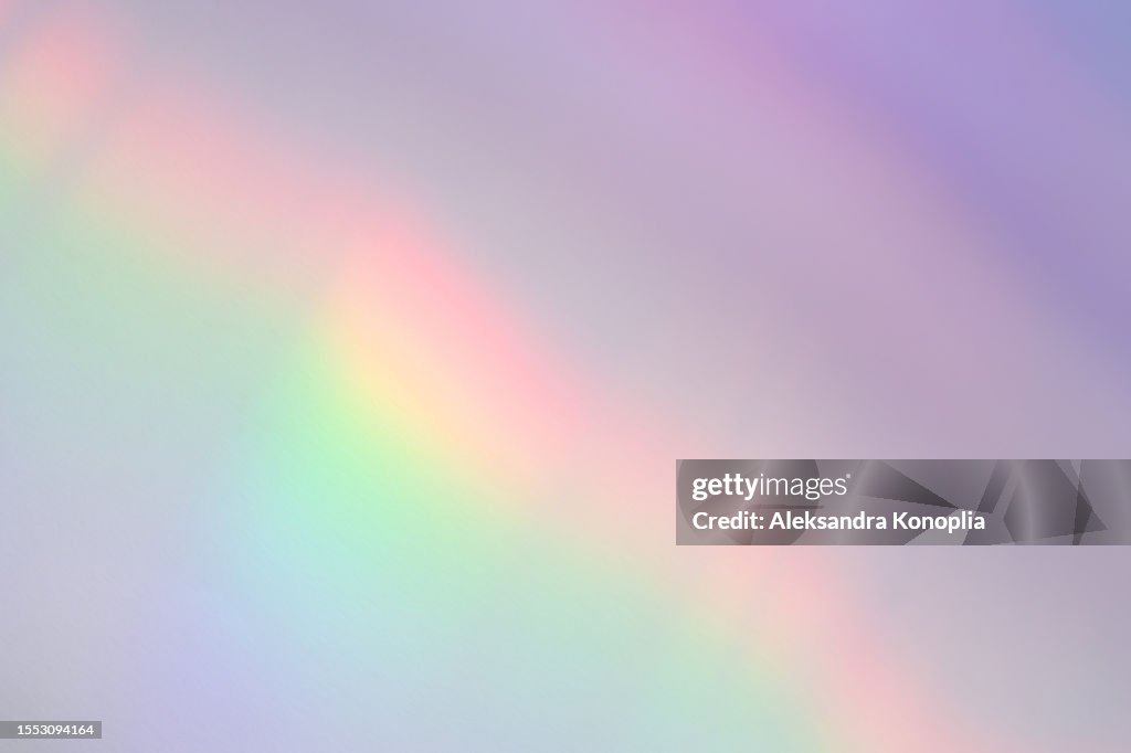 Holographic rainbow gradient color light refraction overlay effect on white wall