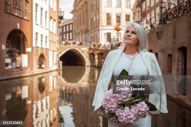 beautiful senior female traveller in utrecht - utrecht stockfoto's en -beelden