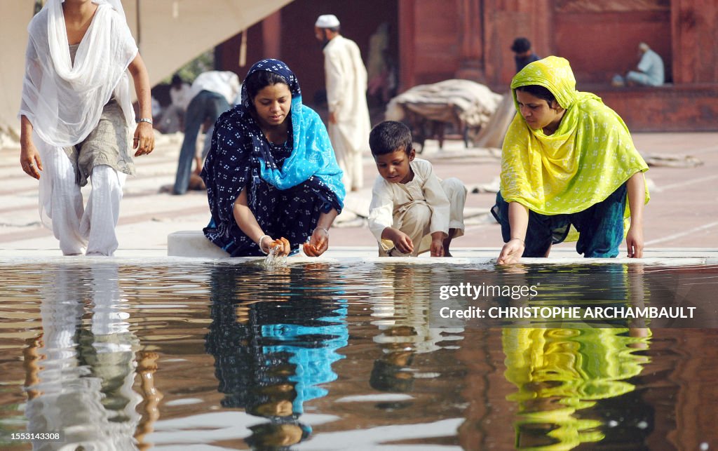 Indian Islam Ritual Indian Muslim women perform ritual ablutions before offering prayers ...