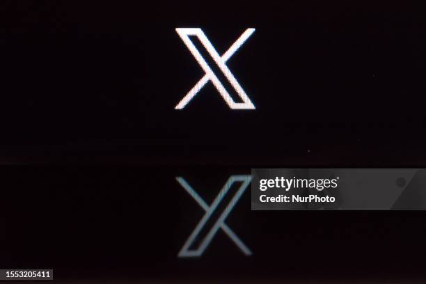 New Twitter logo displayed on a personal computer with reflection on a smartphone screen is seen in L'Aquila, Italy, on July 25, 2023. Twitter...