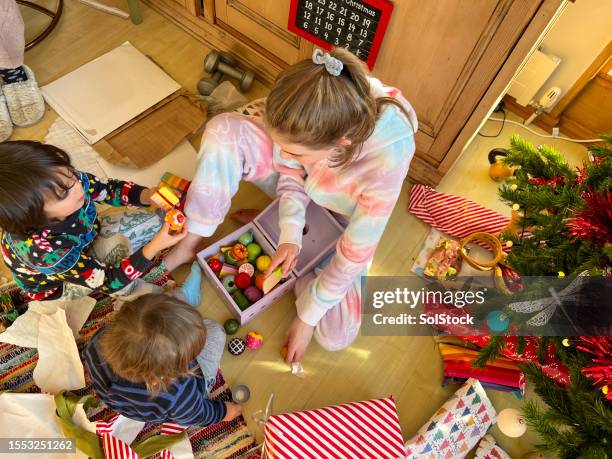 young children playing at christmas time - toddler stock pictures, royalty-free photos & images