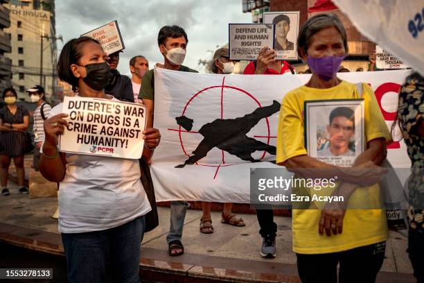 Family members of drug war victims take part in a demonstration following the International Criminal Court's decision to resume its investigation...