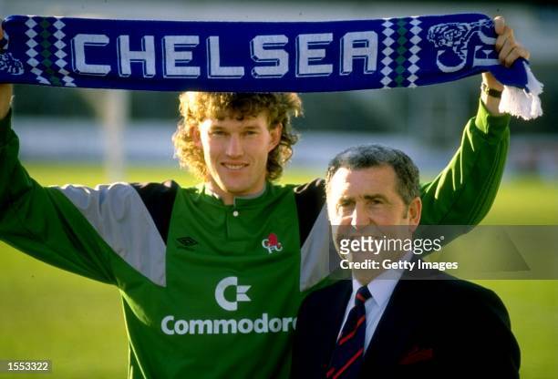 Chelsea Manager Bobby Campbell stands alongside his new goalkeeper Dave Beasant who holds a scarf above his head at Stamford bridge in London,...
