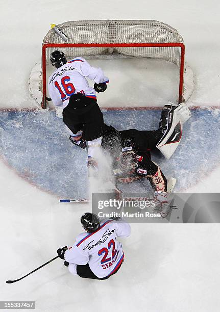 Dimitri Paetzold , goaltender of Hannover stops Eric Chouinard of Nuernberg in front of the net during the DEL match between Hannover Scorpions and...