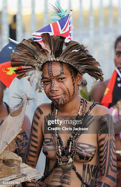 Young Papua dancer looks on as Prince Charles, Prince of Wales and Camilla, Duchess of Cornwall arrive into Jackson's International Airport on...