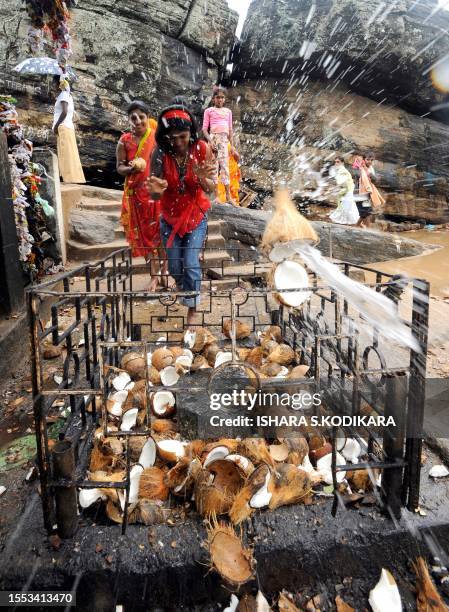 This picture taken on November 2 shows devotees performing rituals at the prominent Hindu temple of Koneswara in the eastern port district of...