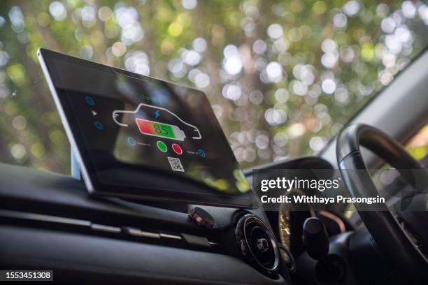 display informs about battery charge level in the electric car - futuristic car interior stock pictures, royalty-free photos & images