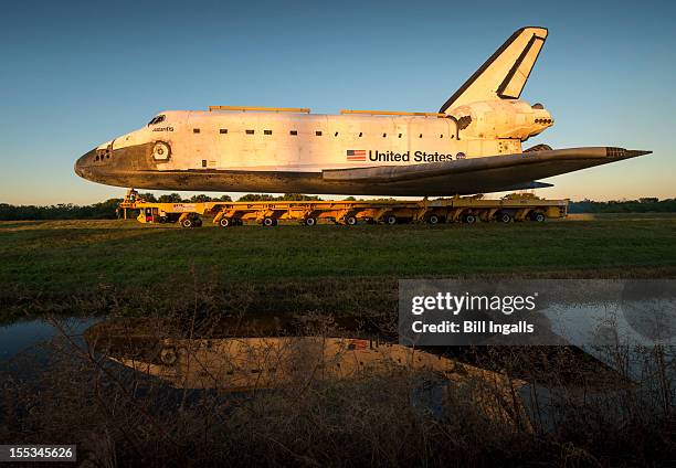 In this handout fromm NASA, the space shuttle Atlantis rolls down Kennedy Parkway on its way to its new home at the Kennedy Space Center Visitor...