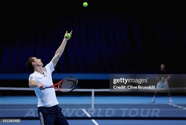 Andy Murray of Great Britain serves to Novak Djokovic of Serbia during a practice session prior to the start of ATP World Tour Finals Tennis at the...