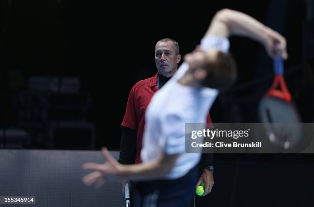 Andy Murray of Great Britain is watched by his coach Ivan Lendl as he serves during a practice session prior to the start of ATP World Tour Finals...