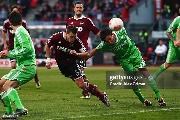 Hanno Balitsch of Nuernberg tries to score with a header against Makoto Hasebe of Wolfsburg during the Bundesliga match between 1. FC Nuernberg and...