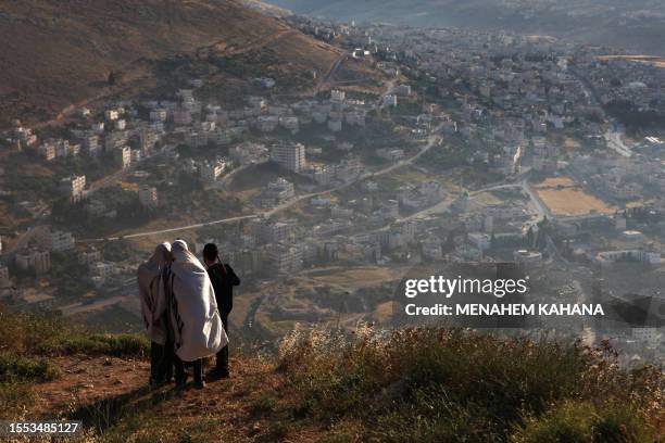 Ultra-Orthodox Jews pray on Mount Gerizim overlooking Joseph's Tomb, one of their holiest sites, in the West Bank city of Nablus on May 28, 2009. The...