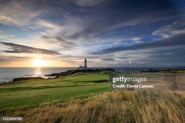 View of the green on the par 3, ninth hole beside The Turnberry Lighthouse as sunset on the Ailsa golf course at Trump Turnberry resort on July 09,...