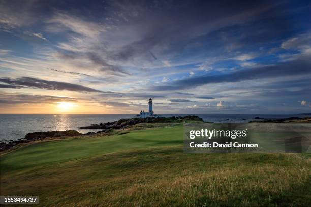 View of the green on the par 3, ninth hole beside The Turnberry Lighthouse as sunset on the Ailsa golf course at Trump Turnberry resort on July 09,...