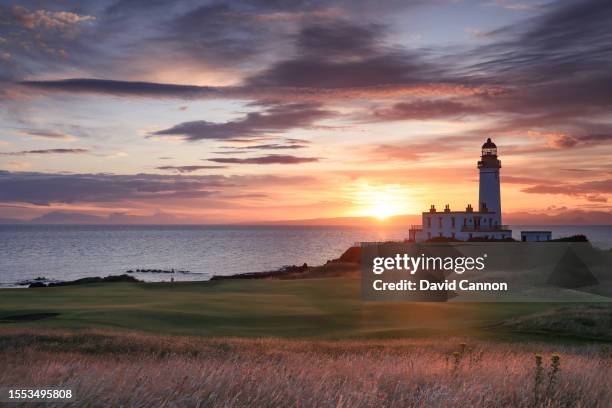 View of the green on the par 3, ninth hole beside The Turnberry Lighthouse as sunset on the Ailsa golf course at Trump Turnberry resort on July 09,...