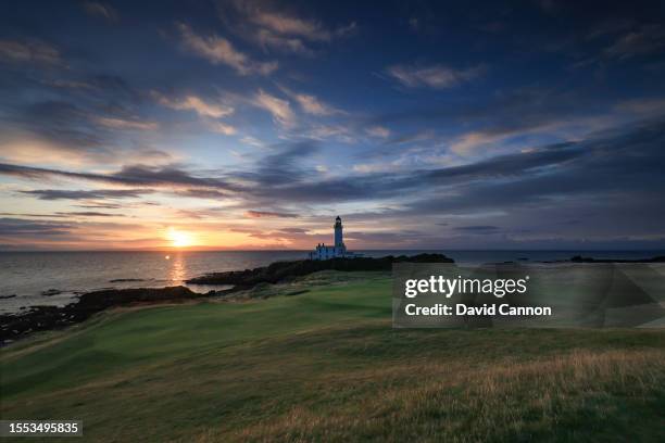 View of the green on the par 3, ninth hole beside The Turnberry Lighthouse as sunset on the Ailsa golf course at Trump Turnberry resort on July 09,...