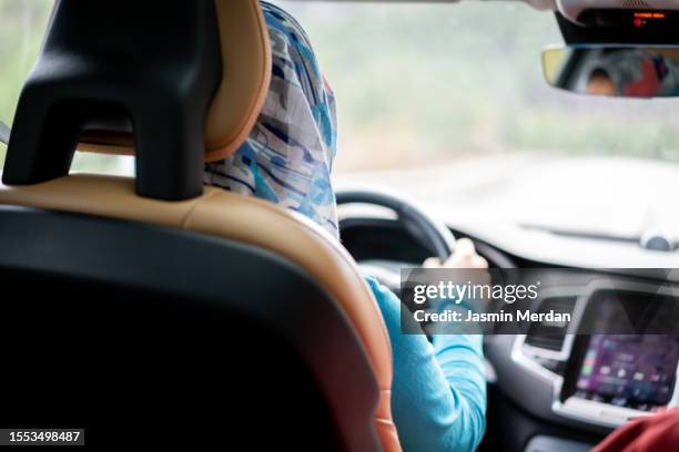 hijabi woman driving car - automotive navigation system stock pictures, royalty-free photos & images