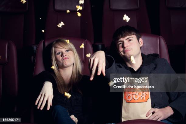 teenagers throwing popcorn at the movie screen - amour 2012 film stock pictures, royalty-free photos & images