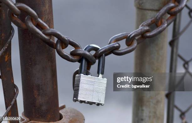 chained and padlocked metal chain link fence. - crime prevention stock pictures, royalty-free photos & images