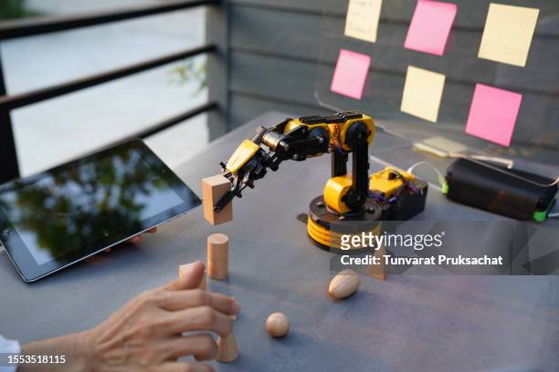 senior engineer works on project ,robotic arm technology . - like ai stock pictures, royalty-free photos & images