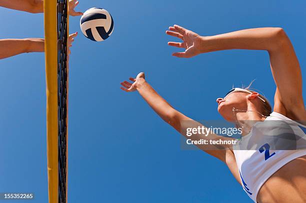 beach volley action on the net - beach volleyball team stock pictures, royalty-free photos & images