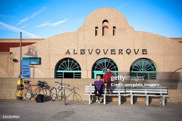 man and woman cyclist sitting at the train station - albuquerque stock pictures, royalty-free photos & images