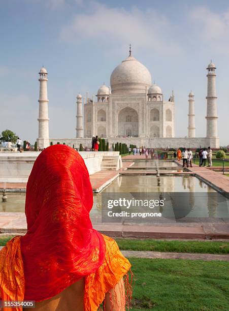 woman with head covered looking at taj mahal - taj mahal palace stock pictures, royalty-free photos & images