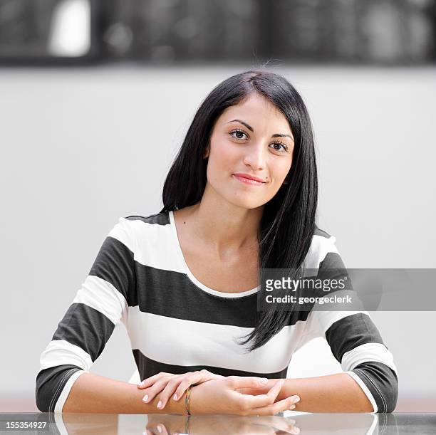 young woman at a desk - studio interview stockfoto's en -beelden