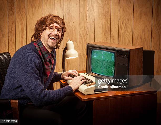 shaggy langhaarigem geeky uncool computer arbeiten mann vintage-stil - computer funny stock-fotos und bilder