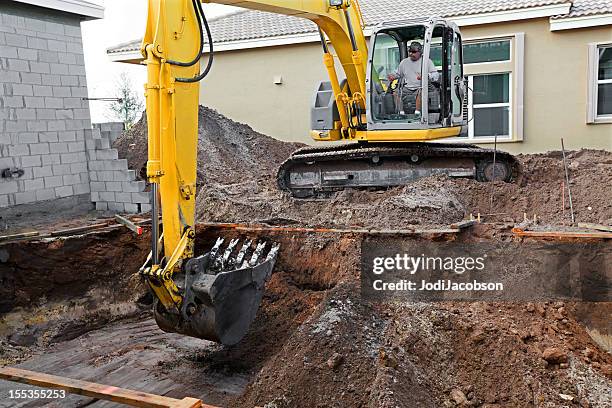 new cement swimming pool construction series - bulldozer house stock pictures, royalty-free photos & images