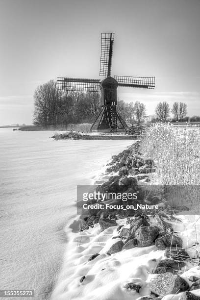windmill during winter - friesland stock pictures, royalty-free photos & images