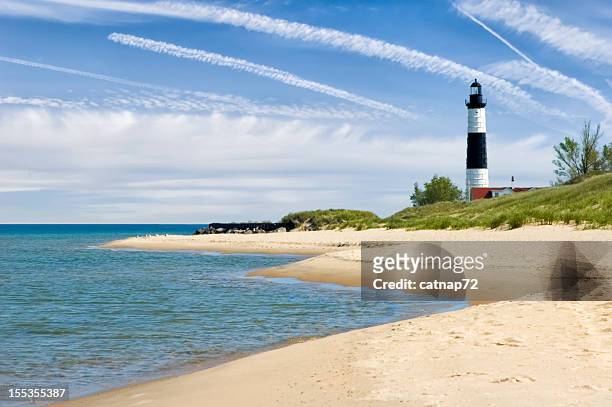 lighthouse and beach in summer with dramatic sky background - michigan summer stock pictures, royalty-free photos & images