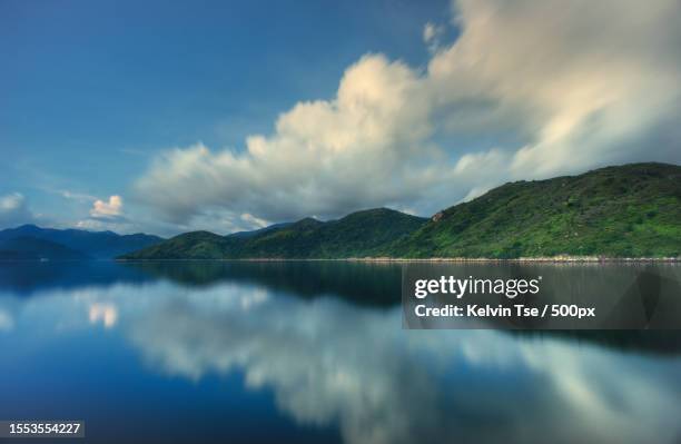 panoramic view of lake and mountains against sky,hong kong - sai kung village stock-fotos und bilder