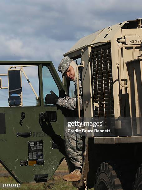 Army soldier Carlos Cuellar of Queens, New York prepares to drive food from the Federal Emergency Management Agency to affected areas of Long Island...