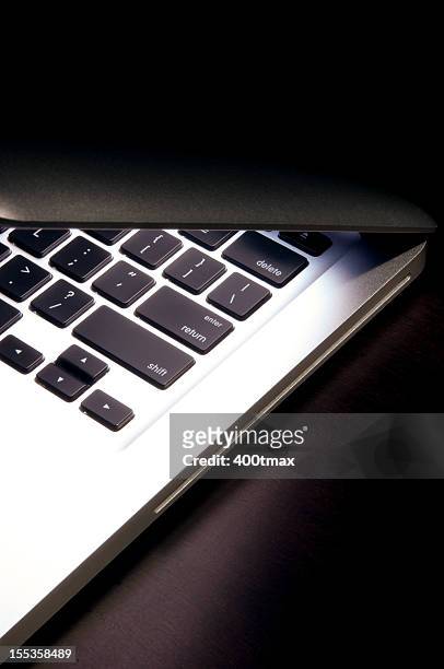 illuminated laptop - closing laptop stock pictures, royalty-free photos & images