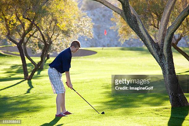 junior golfer ready to swing - golf short iron stock pictures, royalty-free photos & images