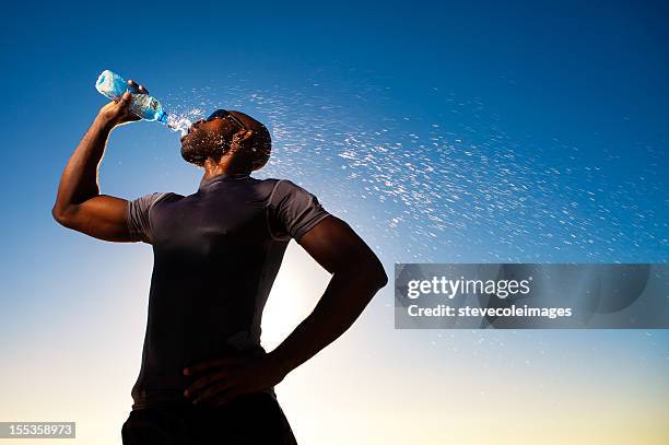 runner drinking bottle water - bodybuilder drinking stock pictures, royalty-free photos & images