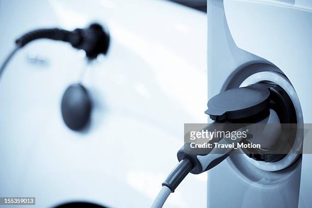 electric vehicle charging, focus on foreground - hybrid vehicle 個照片及圖片檔