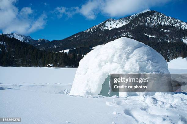 a lone igloo in a mountainous scene - igloo stock pictures, royalty-free photos & images