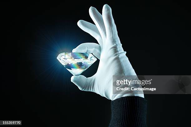 hand wit a diamond - diamond gemstone stock pictures, royalty-free photos & images
