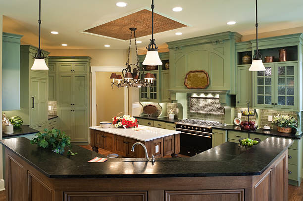 Country style kitchen in a residential home with painted custom cabinets, marble topped center island, soapstone countertops and tin ceiling inlay.