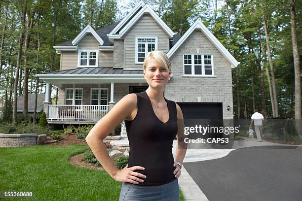 proud wife in front of her family house - family smiling at front door stock pictures, royalty-free photos & images