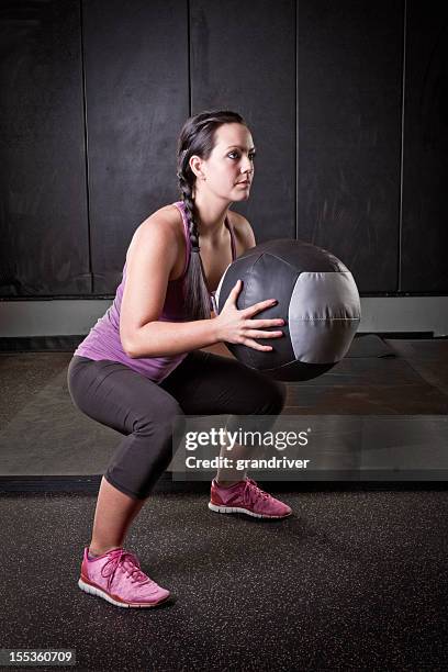 young woman with medicine ball - medicine ball stock pictures, royalty-free photos & images