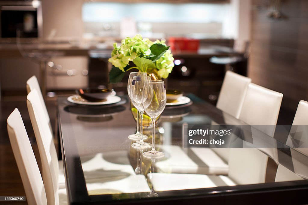 Dining room with kitchen in the background