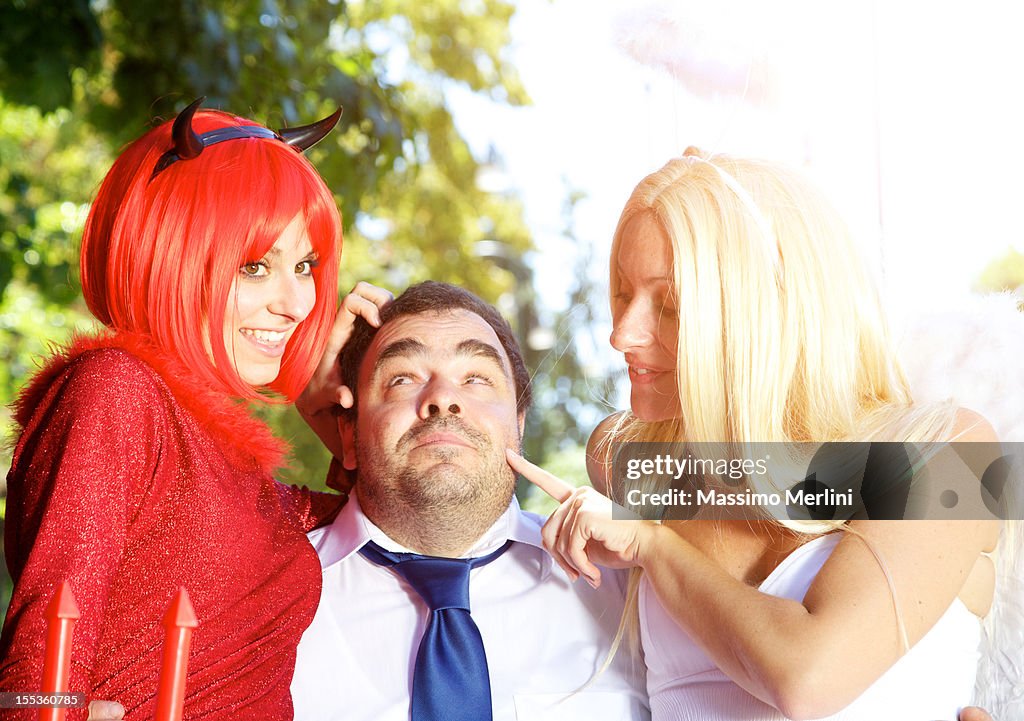 Businessman with angel and devil