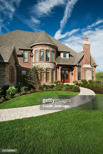 custom built brick home on summer day. - model home exterior stock pictures, royalty-free photos & images